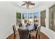 Bright breakfast nook with a round table, padded chairs, and views of the outdoor pool at 8760 N 73Rd Way, Scottsdale, AZ 85258