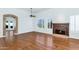 Bright living room features a fireplace, wood floors, an archway and plantation shutters at 8760 N 73Rd Way, Scottsdale, AZ 85258