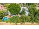 Aerial view showcasing a sparkling pool, patio area, lush trees, and an outdoor dining space at 9310 S Bala Dr, Tempe, AZ 85284