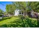 Spacious backyard with manicured lawn, trimmed hedges, and wrought iron fence with seating area provides privacy at 9310 S Bala Dr, Tempe, AZ 85284