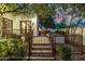 Landscaped backyard featuring a decorative gate, tile steps, and lush greenery offers privacy and charm at 9310 S Bala Dr, Tempe, AZ 85284
