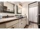 Bathroom featuring double sink vanity, granite countertop, decorative mirrors, and a tile floor at 9310 S Bala Dr, Tempe, AZ 85284