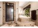 This bathroom offers a walk-in shower and soaking tub with decorative tile surround, providing a spa-like experience at 9310 S Bala Dr, Tempe, AZ 85284