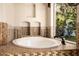 Bright bathroom boasting a soaking tub with tile surround and backyard views through a large window at 9310 S Bala Dr, Tempe, AZ 85284