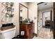 Well-lit bathroom with modern fixtures, storage, and tiled floors with a seperate commode area at 9310 S Bala Dr, Tempe, AZ 85284