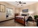 Cozy bedroom features a decorative ceiling fan, natural light, and a window seat for a relaxing retreat at 9310 S Bala Dr, Tempe, AZ 85284