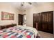 Bedroom featuring a double closet and a doorway to the bathroom, providing privacy and convenience at 9310 S Bala Dr, Tempe, AZ 85284
