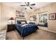 Cozy bedroom features a decorative ceiling fan, natural light, and a window seat for a relaxing retreat at 9310 S Bala Dr, Tempe, AZ 85284