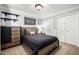Modern bedroom with wood trim, ceiling fan, and a large dresser offers plenty of style and space at 9310 S Bala Dr, Tempe, AZ 85284