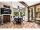 Bright breakfast nook with a charming round table, fish tank, and access to the backyard at 9310 S Bala Dr, Tempe, AZ 85284