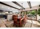 Well-lit dining area featuring a wooden table with seating for six, an elegant chandelier, and access to outdoors at 9310 S Bala Dr, Tempe, AZ 85284