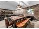 Dining room showcasing a rustic wooden table with chairs, bench, brick accent wall, and unique light fixture at 9310 S Bala Dr, Tempe, AZ 85284