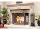 Close-up showcases a stone fireplace, with a warm fire and stylish decorative details at 9310 S Bala Dr, Tempe, AZ 85284