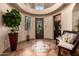 Grand foyer boasts decorative tile, wrought iron door, and archway, creating an inviting entrance at 9310 S Bala Dr, Tempe, AZ 85284