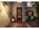 A close-up of the front door with stonework, wrought iron, and a decorative light fixture at 9310 S Bala Dr, Tempe, AZ 85284