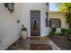 Detailed shot of front door entrance with stonework, wrought iron, and welcome mat at 9310 S Bala Dr, Tempe, AZ 85284