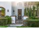 Close-up of gated front entrance leading to the main doorway, with lush landscaping at 9310 S Bala Dr, Tempe, AZ 85284