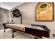 Game room boasting a shuffleboard table, accent lighting, brick wall, and neutral carpet at 9310 S Bala Dr, Tempe, AZ 85284
