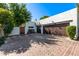 Spacious brick driveway with wooden garage doors and mature landscaping at 9310 S Bala Dr, Tempe, AZ 85284