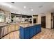 Expansive kitchen featuring a large island, custom cabinetry, and tiled flooring at 9310 S Bala Dr, Tempe, AZ 85284