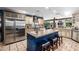 Gourmet kitchen featuring a large island with seating and stainless steel appliances at 9310 S Bala Dr, Tempe, AZ 85284