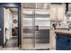 Stainless steel fridge surrounded by custom cabinets with tiled floors throughout at 9310 S Bala Dr, Tempe, AZ 85284