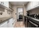 This efficient laundry room offers granite counters, a utility sink, built-in seating and storage, plus modern appliances at 9310 S Bala Dr, Tempe, AZ 85284