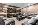 Living room showcasing modern furniture, wood and brick accent wall, entertainment center, and recessed lighting at 9310 S Bala Dr, Tempe, AZ 85284