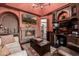 Inviting living space features a stone fireplace, TV, and built-in bookshelves for added style at 9310 S Bala Dr, Tempe, AZ 85284