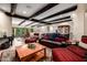 Relaxing living space features beamed ceilings, comfortable seating, and seamless access to the outdoors at 9310 S Bala Dr, Tempe, AZ 85284
