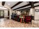 Open living room boasts beamed ceilings, a fireplace, and stylish decor, blending comfort and elegance at 9310 S Bala Dr, Tempe, AZ 85284