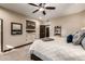Bedroom featuring plush carpet, large windows and doorway and a mounted television at 9310 S Bala Dr, Tempe, AZ 85284