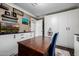 Office space with cabinets, drawers, shelving, a statement chair, and a wooden desk at 9310 S Bala Dr, Tempe, AZ 85284