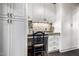 Cozy built-in office nook with white cabinets, a granite counter, and a comfortable chair at 9310 S Bala Dr, Tempe, AZ 85284
