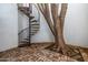 Unique outdoor space with a spiral staircase and a decorated tree, creating a magical ambiance at 9310 S Bala Dr, Tempe, AZ 85284