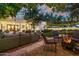 Spacious patio featuring a fire pit, comfortable seating, and outdoor lighting, perfect for evening gatherings at 9310 S Bala Dr, Tempe, AZ 85284