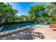 Private backyard features a spacious pool, lounge chairs, and neat brick patio with a serene atmosphere at 9310 S Bala Dr, Tempe, AZ 85284