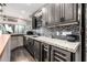 This stylish wet bar has custom cabinets, granite countertops, wine cooler, and decorative backsplash, perfect for entertaining at 9310 S Bala Dr, Tempe, AZ 85284