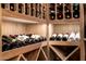 This custom wine cellar features wooden shelving and storage for a large collection of wine at 9310 S Bala Dr, Tempe, AZ 85284