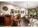 Enjoy the spacious wine room with a wet bar, barrel table, and elegant decor at 9310 S Bala Dr, Tempe, AZ 85284