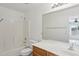 Bright bathroom featuring a shower-tub combo, toilet, and vanity with a sink and large mirror at 9420 S 35Th Gln, Laveen, AZ 85339