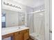 Bathroom featuring new tile, a shower with glass doors, and a wooden vanity at 9420 S 35Th Gln, Laveen, AZ 85339