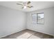 This cozy bedroom offers natural light through a window and features a ceiling fan at 9420 S 35Th Gln, Laveen, AZ 85339