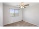 This bedroom features a ceiling fan and a window offering serene outdoor views at 9420 S 35Th Gln, Laveen, AZ 85339