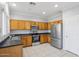 Kitchen featuring stainless steel appliances, plenty of cabinets, and easy access to a door to the outside at 9420 S 35Th Gln, Laveen, AZ 85339