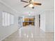 Open-concept living space flowing into a kitchen with wood cabinets and stainless steel appliances at 9420 S 35Th Gln, Laveen, AZ 85339