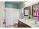 Bright bathroom with double sinks, modern fixtures, and a shower-tub combination at 10010 W Illini St, Tolleson, AZ 85353