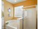 Bright bathroom featuring a soaking tub with a tile surround and a glass enclosed shower at 10010 W Illini St, Tolleson, AZ 85353