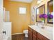 Bathroom featuring a double vanity with mirrors, neutral colored tile, and a walk-in shower at 10010 W Illini St, Tolleson, AZ 85353