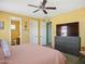 Bright bedroom showcasing a ceiling fan, and a large dresser with a television at 10010 W Illini St, Tolleson, AZ 85353